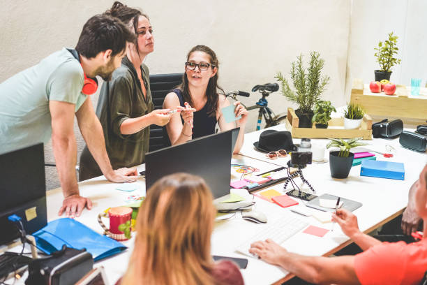 istock Young co-workers team talking during startup - Happy people planning a new project in creative workplace office - Focus on woman with glasses face - Technology, entrepreneur, marketing  concept 1078040502