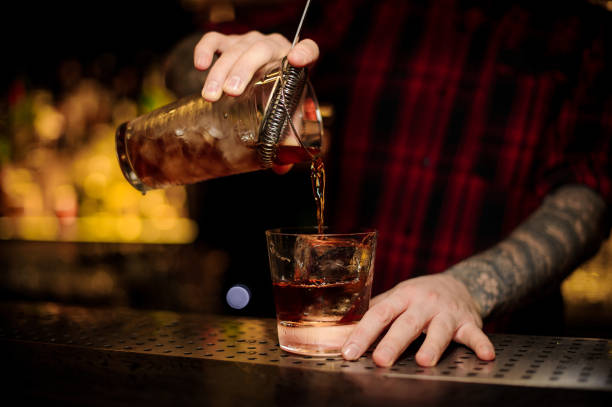 istock Bartender pouring a delicious Godfather cocktail from the measuring cup 1078043644