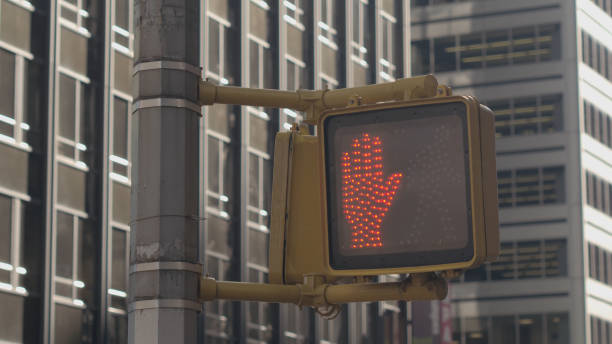 istock CLOSE UP: Pedestrian crossing light turning from walking man sign to red hand 1078044754
