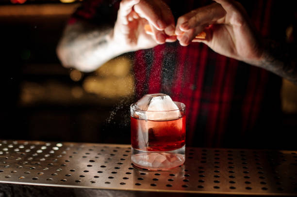 istock Bartender adding to a Boulevardier cocktail orange zest juice 1078046306