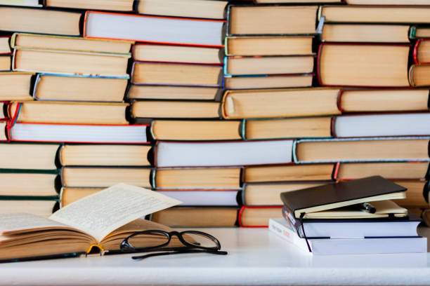 istock Books background, glasses and notebook on white wooden table 1078057922