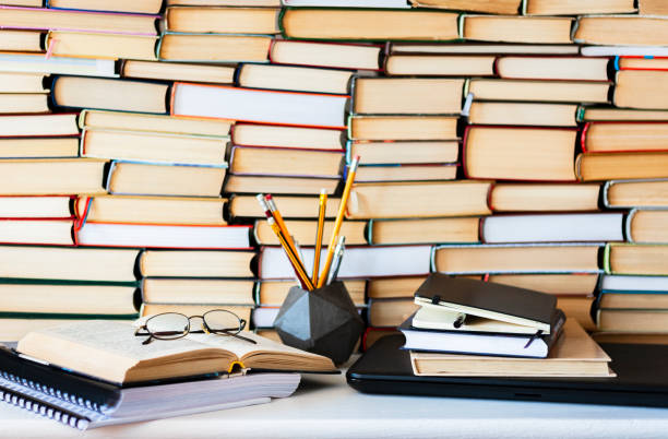 istock Books background, glasses and notebook on white wooden table 1078058412