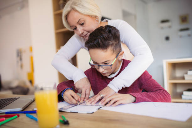 istock Mom and son doing homework at home 1078059852