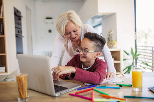 istock Mother and son doing homework on laptop 1078060176