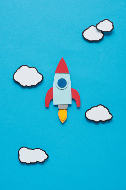 istock top view of paper rocket with clouds on blue background, setting goals concept 1078060400