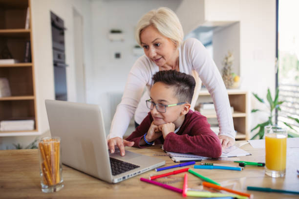 istock Mom and son doing homework on laptop 1078060448