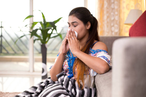 istock Sick woman blowing her nose 1078063912