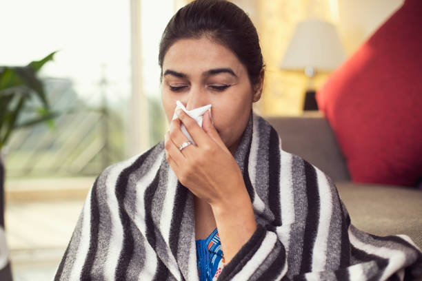 istock Sick woman blowing her nose 1078065000