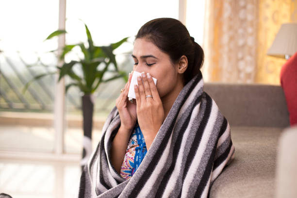 Sick woman blowing her nose