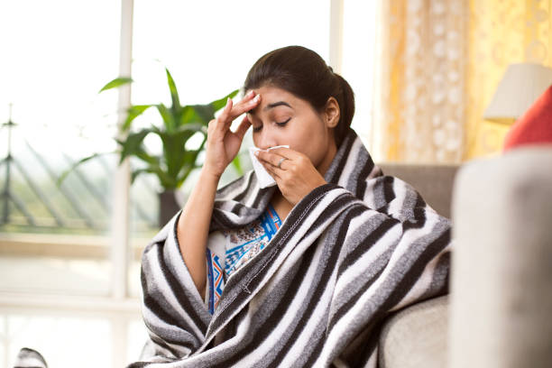 istock Sick woman blowing her nose 1078067812