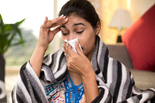 istock Sick woman blowing her nose 1078068360