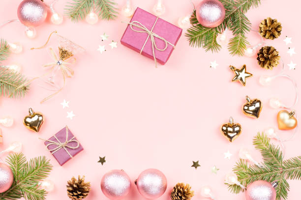 istock Christmas background with fir branches, lights, pink decorations on pink 1078068840
