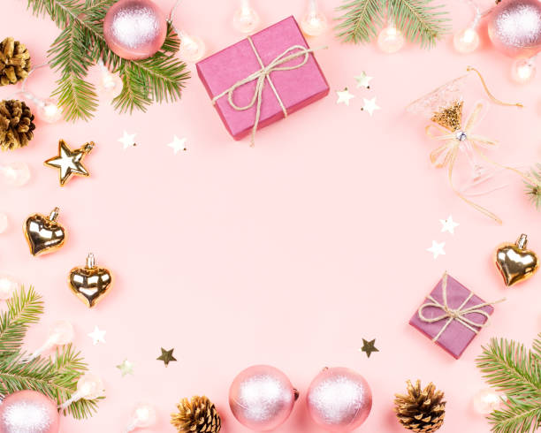 istock Christmas background with fir branches, lights, pink decorations on pink 1078068990