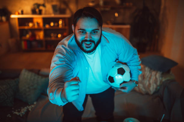istock Chubby man watching a soccer match 1078071314