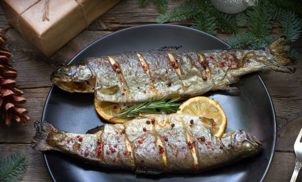 istock Christmas trout baked fish on table with ornament 1078071380