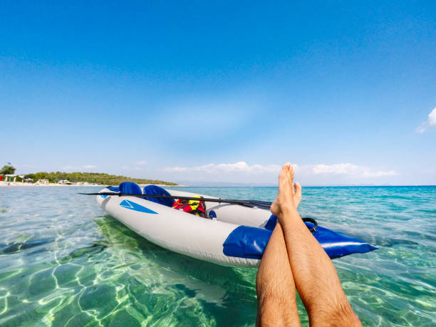 Floating on the sea after kayaking Personal perspective of a man having fun floating on the water after kayaking on the Aegean sea in Greece. halkidiki stock pictures, royalty-free photos & images