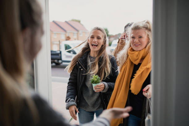 Greeting Guests at Housewarming Party