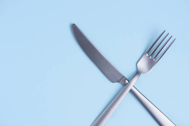 istock Crossed silver metal knife and fork sign 1078079226