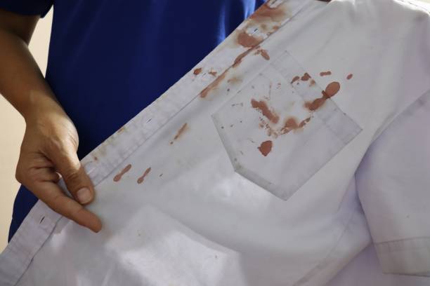 istock hand holding a bloody white shirt 1078079300
