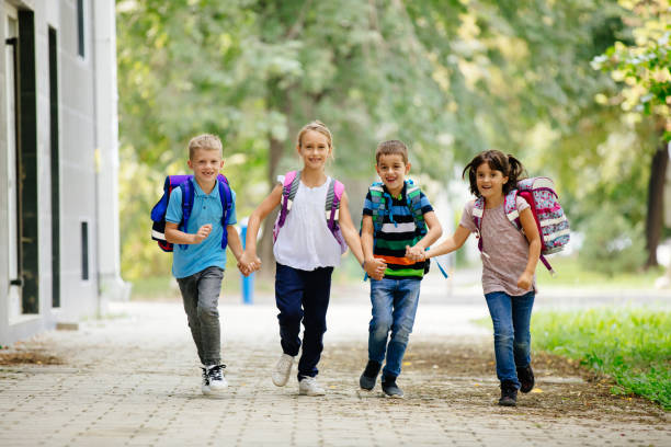 istock School children holding hands and going to school together 1078079706