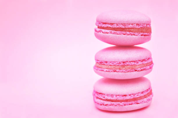 istock Pink macarons on pastel valentine decor and rose flowers background 1078080878