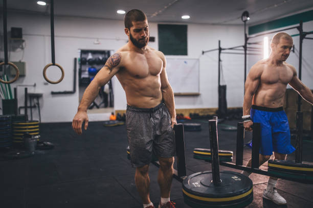 istock Two muscular men working out in gym 1078081516