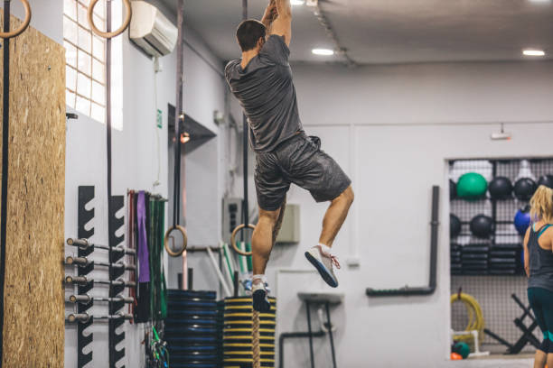 istock Muscular man climbing rope 1078081656