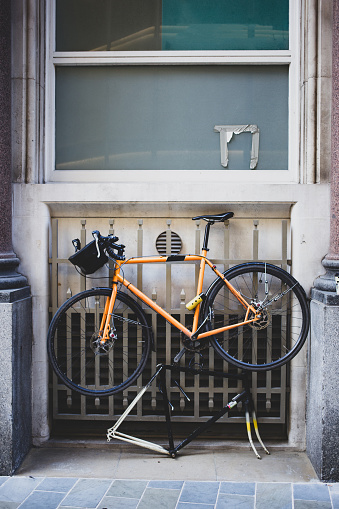 Racing bike securely locked hanging up against railings in a London side street