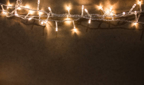 istock Yellow garland on a dark background. Background with a warm light. Copy space, selective focus. 1078084562