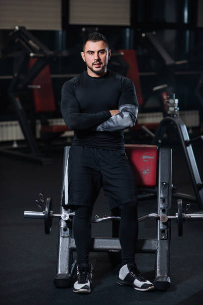 istock Handsome man with big muscles, posing at the camera in the gym 1078090872