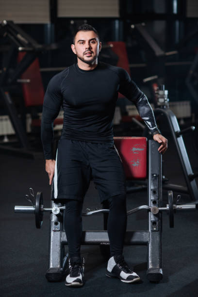 istock Handsome man with big muscles, posing at the camera in the gym 1078090880