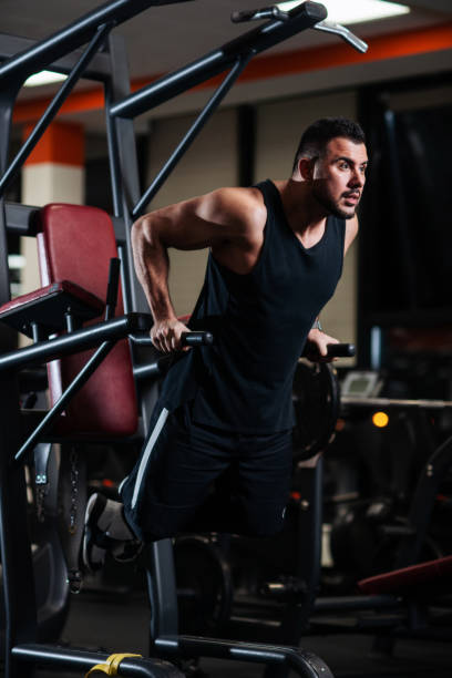 istock Muscular man during a workout at the gym trains the triceps on the parallel bars 1078092504