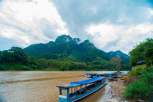 Boat with view over the Nam Ou river and the Limestone mountains from the village of Nong Khiaw in Laos