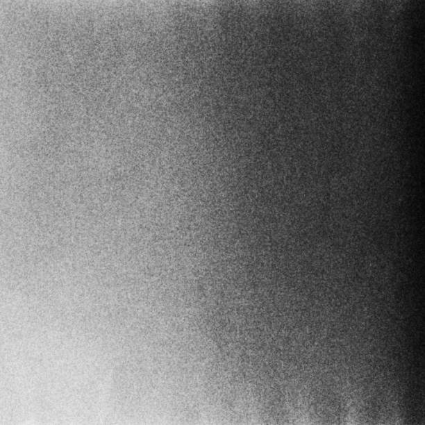 istock Black and white textured background with light leaks and grain. 1078093390