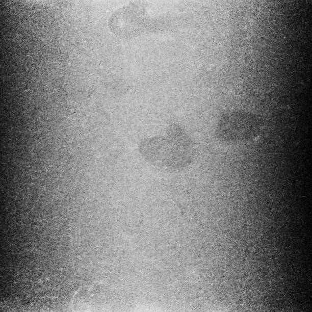 istock Black and white textured background with light leaks and grain. 1078093428