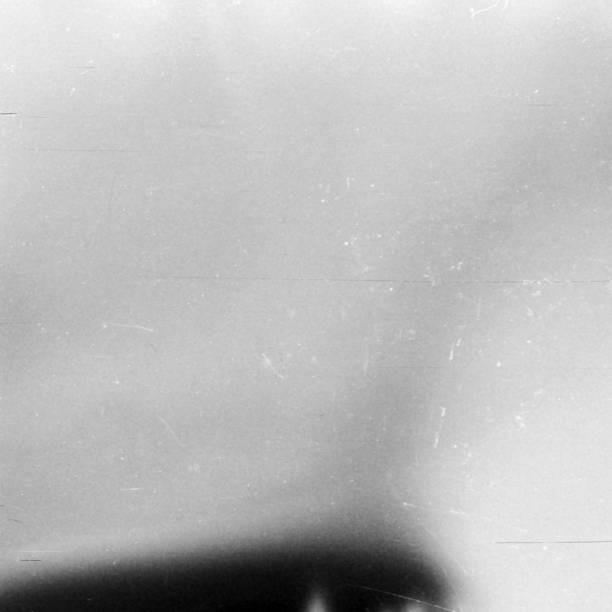 istock Black and white textured background with light leaks and grain. 1078093442