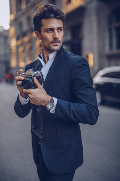 istock Young man photographing on the street 1078093976