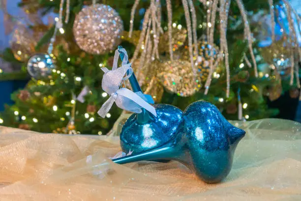 blue christmas baubles with decorated xmas tree background
