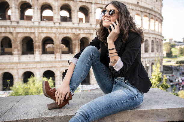 istock Smiling woman sitting in front of Coliseum 1078101704