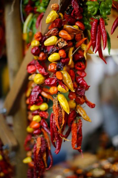 istock String of multi-coloured chilli peppers in market 1078101754