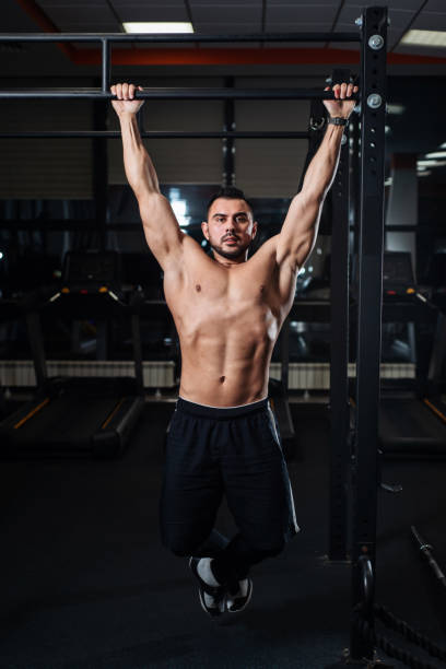 istock Athletic man making pull-up exercises on a crossbar in the gym 1078108958