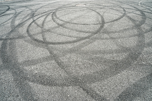 Abstract of Black tire wheels caused by car on the road