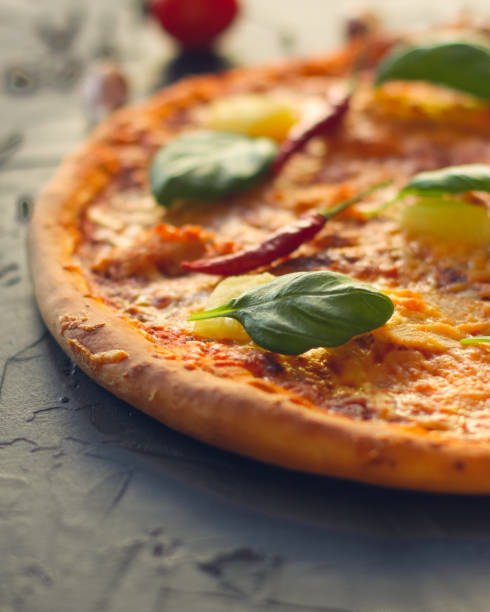 istock pizza, pineapples, chicken, tomato sauce, vegetables, basil (pizza ingredients). food background. copy space 1078111630