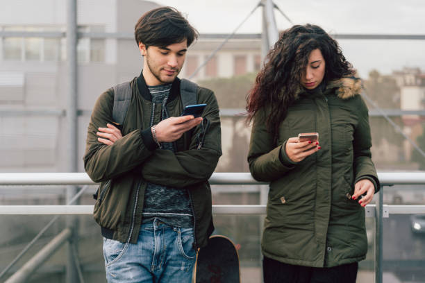istock Teenagers friends using smartphones together 1078120420