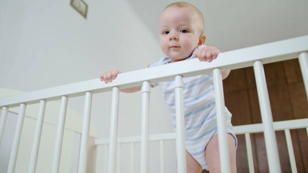 istock Cute Baby Playing in her Crib at Home 1078120898