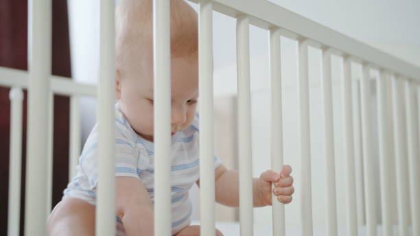 istock Cute Baby Playing in her Crib at Home 1078121492
