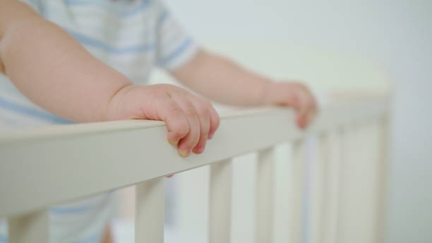 istock Cute Baby Playing in her Crib at Home 1078122150