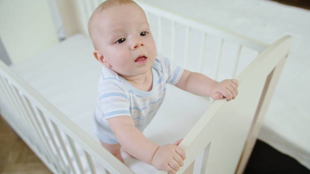 istock Cute Baby Playing in her Crib at Home 1078122560
