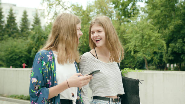 istock Young Ladies Using a Phone in Town 1078133470