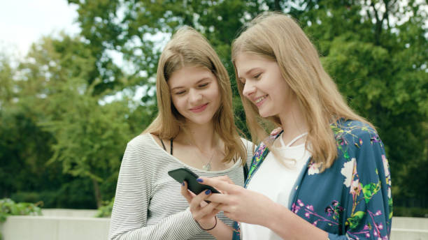 istock Young Ladies Using a Phone in Town 1078133538